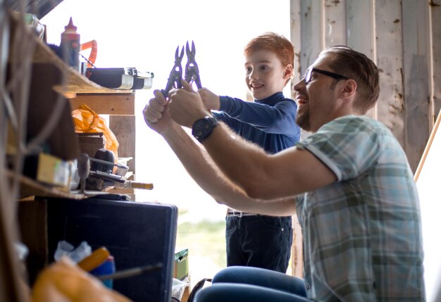 Foto nahaufnahme des glücklichen vaters und seines kleinen sohnes arbeiten zusammen am konzept der familienerziehung