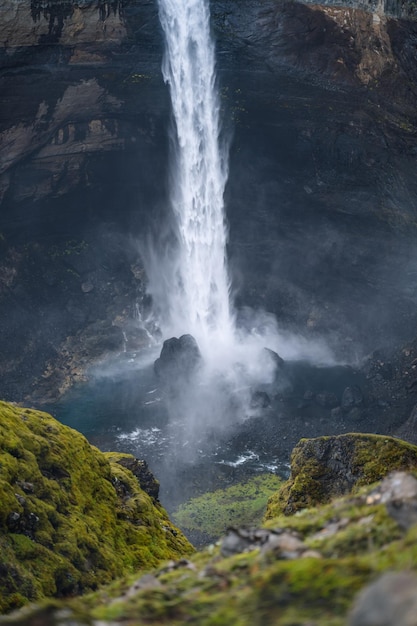 Nahaufnahme des Haifoss-Wasserfalls im Süden Islands. Das Wasser prasselt gegen die Felsen am Grund