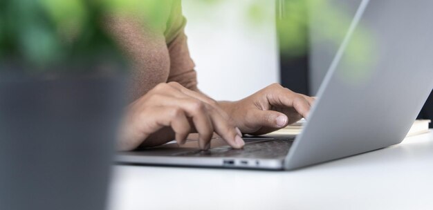 Foto nahaufnahme einer frau, die die tastatur auf dem laptop drückt