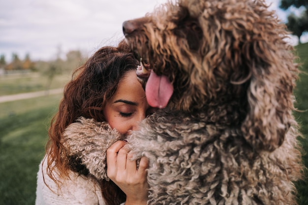 Foto nahaufnahme einer frau, die im park mit einem hund spielt