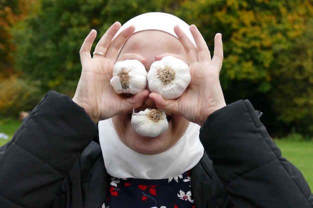 Foto nahaufnahme einer frau mit knoblauchzwiebeln