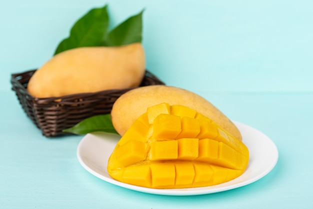 Nahaufnahme einer Mango auf einem Teller mit blauem Hintergrund