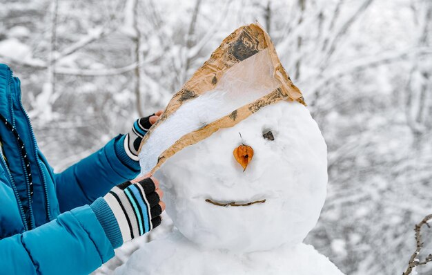 Nahaufnahme einer Person, die einen Schneemann macht