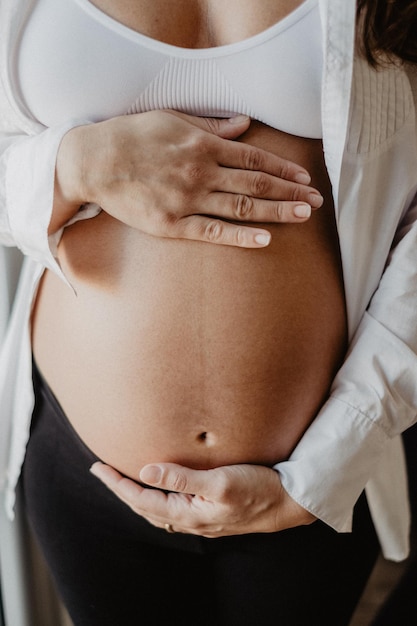 Nahaufnahme einer schwangeren Frau, die den Bauch berührt