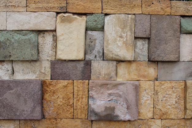 Nahaufnahme einer Wand, die aus mehreren farbigen Natursteinen besteht