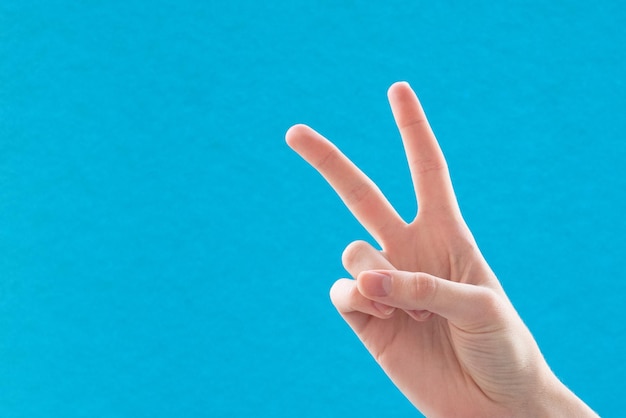 Nahaufnahme einer weiblichen Hand mit zwei Fingern ein Symbol des Friedens oder des Sieges Zeichen für den Buchstaben V in Gebärdensprache