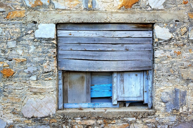 Nahaufnahme eines alten Holzfensters auf einem alten Bauernhaus Historischer Fensterflügel und Wand eines alten oder antiken Gebäudes Ein Tourismus- oder Besichtigungsort, um Geschichte und alte Architektur zu lernen