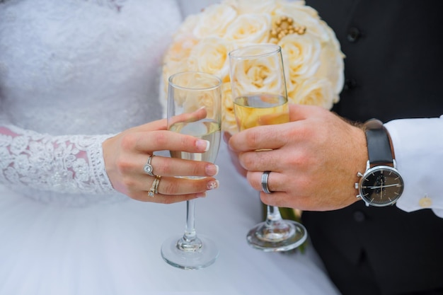 Nahaufnahme eines Paares, das auf der Hochzeit Champagnergläser klingelt