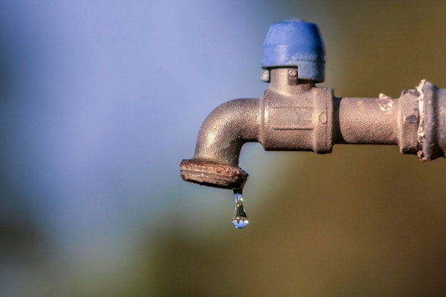 Foto nahaufnahme eines wassertrops, der aus dem wasserhahn fällt