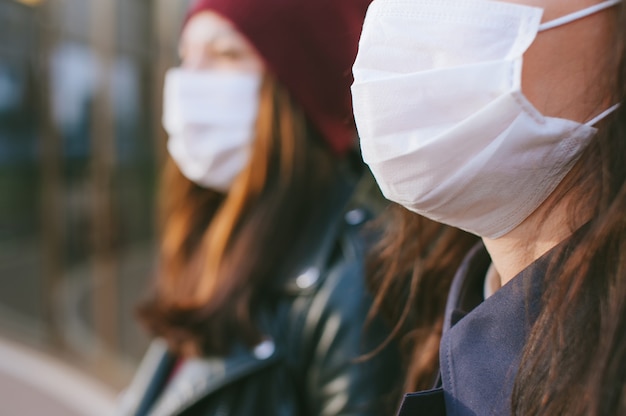 Nahaufnahme, Maske auf einem Mann auf dem Hintergrund eines Mädchens mit einer Maske in der Ferne.