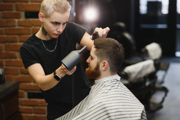 Nahaufnahme, Meister Friseur macht Frisur und Stil mit Schere und Kamm.