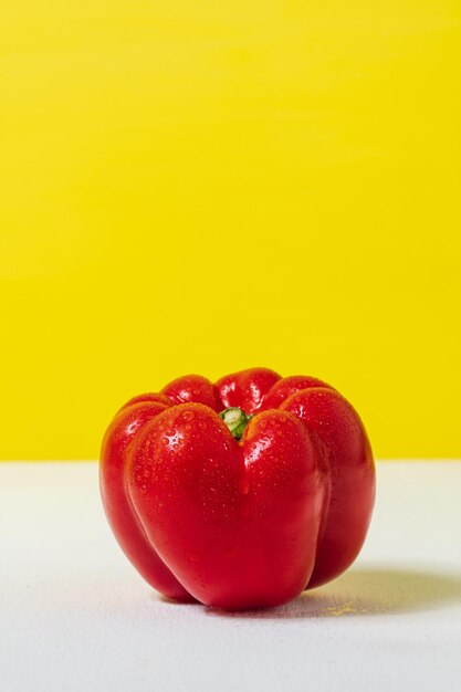 Nahaufnahme süßer roter Pfeffer für gesundes auf gelbem weißem Hintergrund Diätnahrung und veganes Konzept