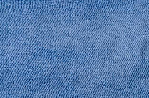 Foto nahaufnahme von denim-texturdetails, die die einzigartigen linien und webarten hervorheben. ein perfektes bild zur darstellung