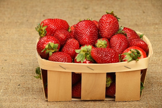Nahaufnahme von Erdbeeren in einer Schachtel auf einem Teppich