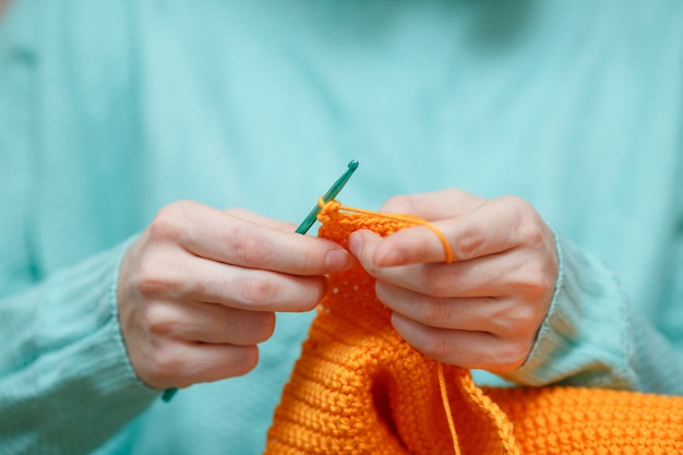 Nahaufnahme von Frau Hand häkeln Wollpullover