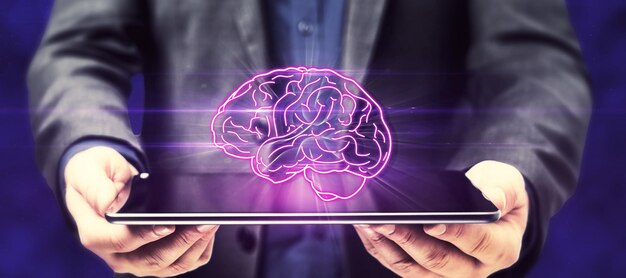 Nahaufnahme von Geschäftsmannhänden, die ein Tablet mit leuchtendem menschlichem Gehirn auf dunklem Hintergrund halten Künstliche Intelligenz und Innovationskonzept