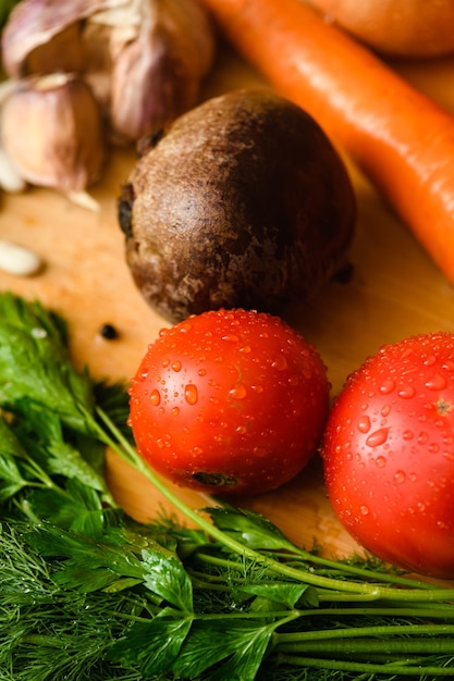 Nahaufnahme von Tomaten mit verschiedenem Gemüse zum Kochen von Borschtsch