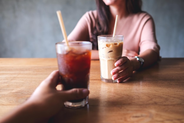 Nahaufnahmebild von ein paar leuten, die zusammen kaffee im café halten und trinken