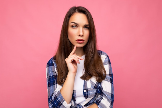 Nahaufnahmefoto der erstaunlichen nachdenklichen schönen jungen Frau tief denkenden kreativen weiblichen Person, die Arm auf Kinn trägt stilvolles Outfit lokalisiert auf bunt