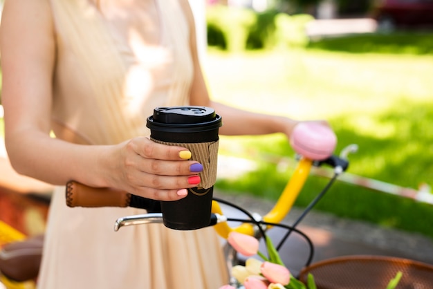 Nahaufnahmekaffeegriff durch eine stilvolle Frau