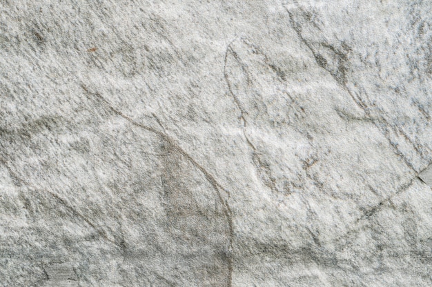 Nahaufnahmeoberfläche am Steinmuster an der Steinbacksteinmauer im strukturierten Hintergrund des Gartens