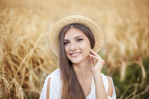 Nahaufnahmeporträt Beauty Girl im Weizenfeld bei Sonnenuntergang.