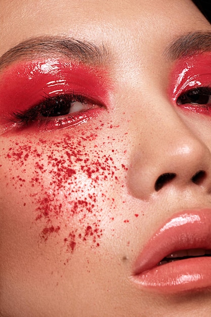 Nahaufnahmeporträt der asiatischen Frau mit kreativem Make-up