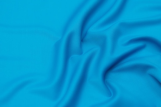 Nahaufnahmetextur aus natürlichem blauem Stoff oder Stoff in derselben Farbe Stoffstruktur aus natürlicher Baumwollseide oder Wolle oder Leinen Textilmaterial Blauer Leinwandhintergrund
