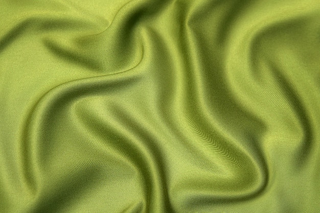 Nahaufnahmetextur aus natürlichem grünem oder braunem Stoff oder Stoff in derselben Farbe. Gewebestruktur aus natürlicher Baumwolle, Seide oder Wolle oder Leinentextilmaterial. Farbe Leinwand Hintergrund.