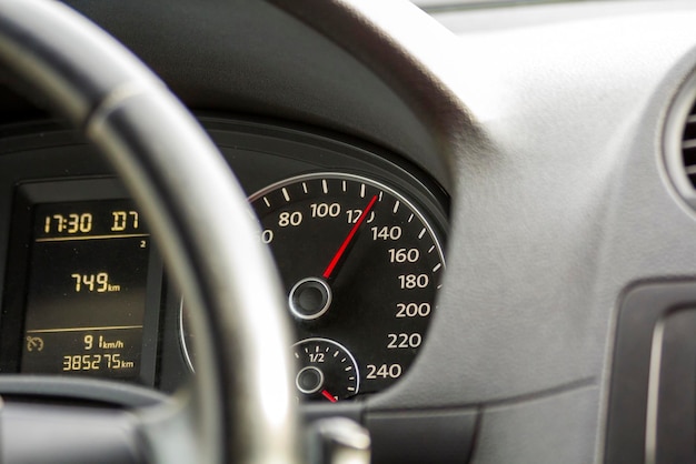 Nahaufsicht auf das Innere eines modernen luxuriösen schwarzen Autos Armaturenbrett Lenkrad Geschwindigkeitsmesser Geschwindigkeit Komfort und Luxus