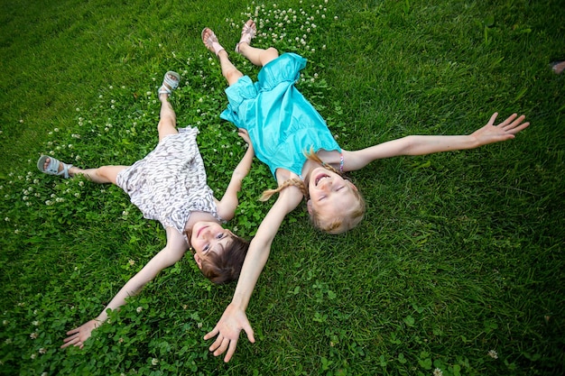 Namoradas meninas sorridentes na grama verde. feriados infantis