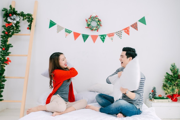 Natal. Casal asiático em casa comemorando o ano novo.