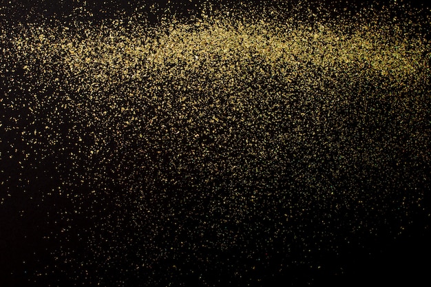 Natal glitter dourados sobre fundo preto. Resumo de férias