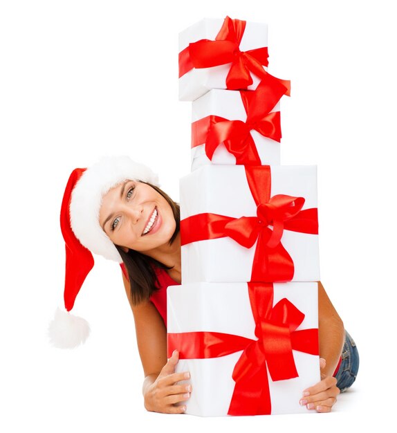 Natal, natal, inverno, conceito de felicidade - mulher sorridente com chapéu de ajudante de papai noel com muitas caixas de presente