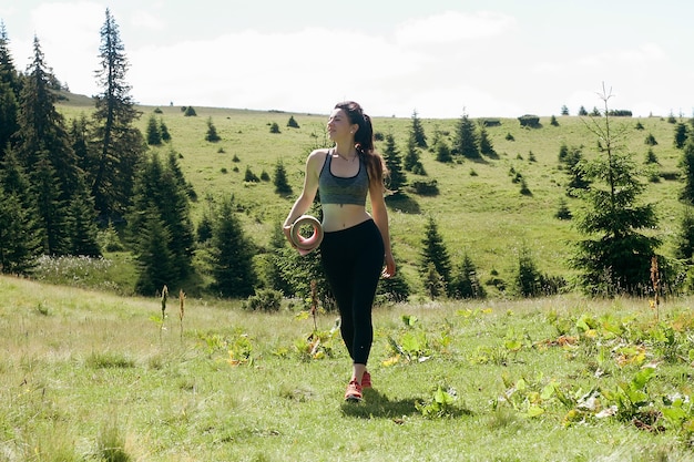 Natürlich, Sport, Gesundheit, Menschen, Lifestyle-Konzept - Gesunde junge, unabhängige Yogapraktikerin, die Meditation praktiziert und eine schöne, ruhige Aussicht auf die Berge mit Blick auf die Reinheit posiert