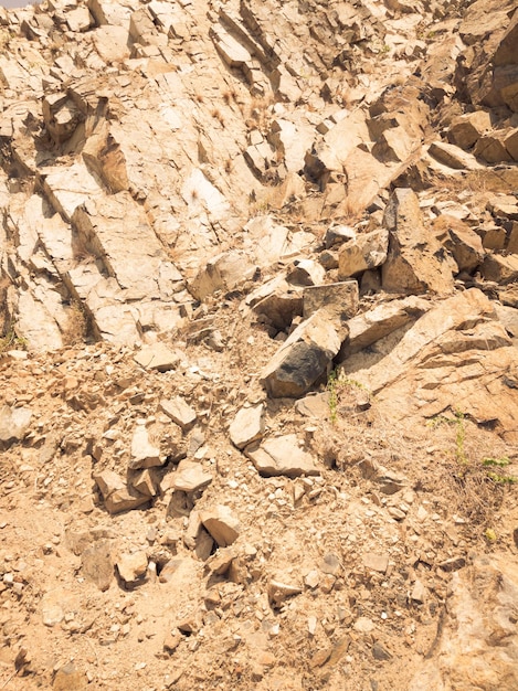 Natürlicher Hintergrund Nahaufnahme umrandete schäbige Klippenrisse Graubraune Steinfelsenstruktur der Berge Vintage und verblasste matte Stilfarbe in getöntem Foto Konzept des geologischen Bergsteigens oder harter Arbeit