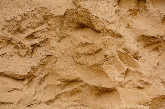 Natürlicher Hintergrund Textur der Sandwand im Sandkasten