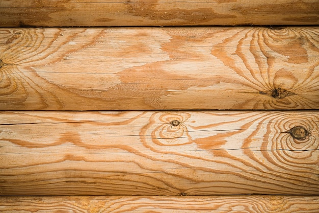 Foto natürliches hintergrundmuster der blockmauer bau von häusern aus abgerundetem holz