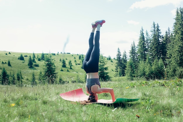 Natural, deporte, salud, personas, concepto de estilo de vida - joven practicante de yoga independiente saludable, practicando meditación y posa montaña hermosa vista serena con vistas a la pureza