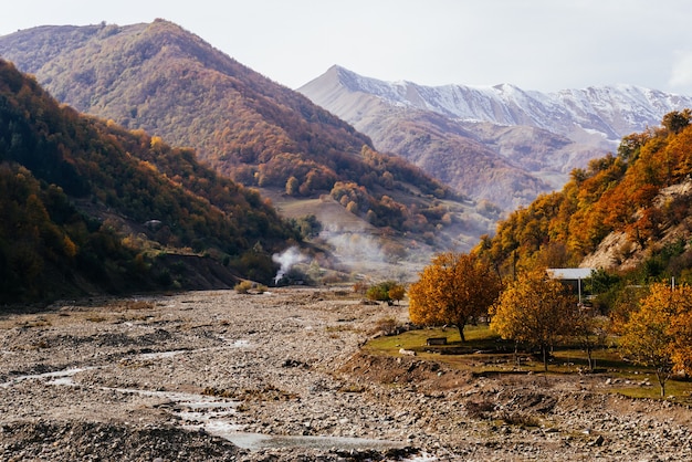 Natureza majestosa e encantadora, as encostas das montanhas estão cobertas de plantas e árvores, fumaça do fogo