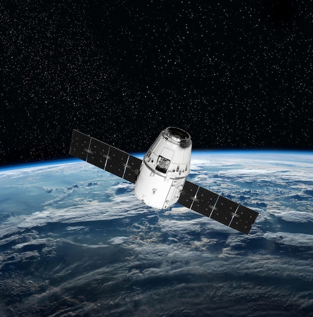 Nave espacial de carga y planeta Tierra. Fondo oscuro. Fondo de pantalla de ciencia ficción. Estación espacial orbitando la Tierra. Nave espacial. Papel tapiz de arte espacial Observatorio solar Elementos de esta imagen proporcionados por la NASA.
