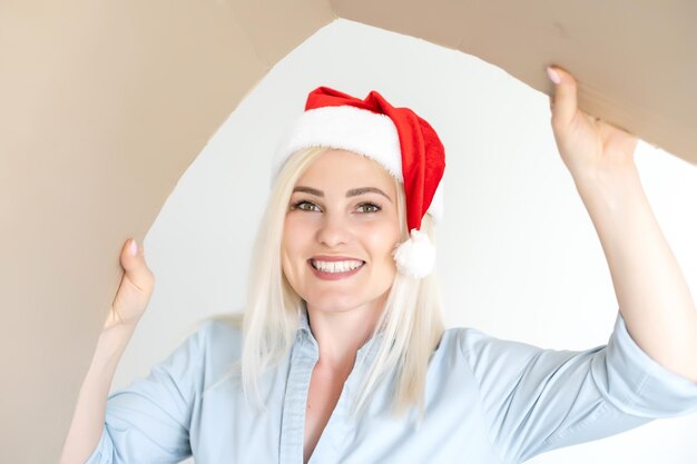 Navidad, Navidad, invierno, concepto de felicidad - mujer sonriente con sombrero de ayudante de santa con caja de paquetería