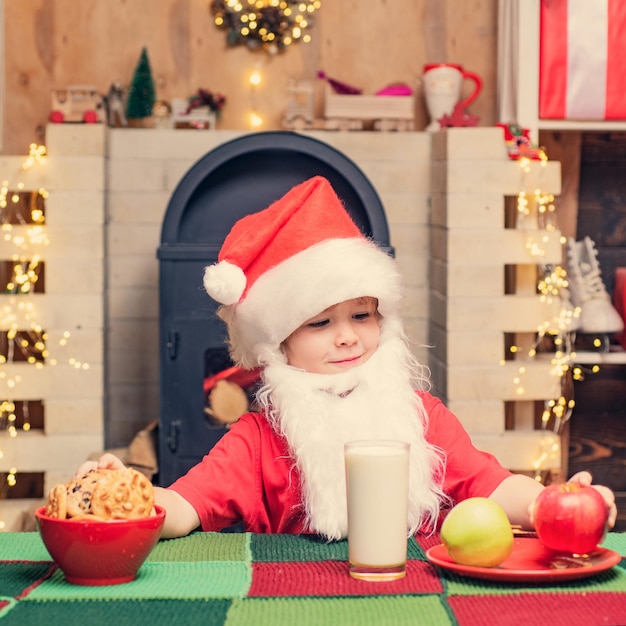 Navidad niño día de acción de gracias y navidad santa claus niño niño comiendo galletas y bebiendo ...