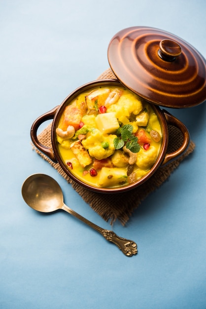 Foto navratan korma é um prato mughlai rico, cremoso e saboroso da índia que se traduz literalmente em curry de nove gemas. as gemas são as frutas, vegetais e nozes que compõem o curry