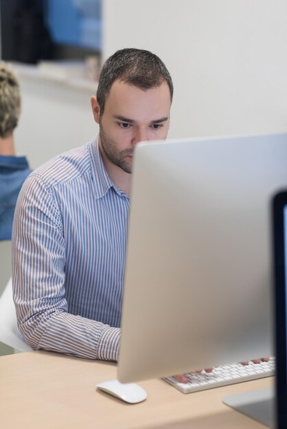 negocio de inicio, desarrollador de software que trabaja en una computadora de escritorio en una oficina moderna