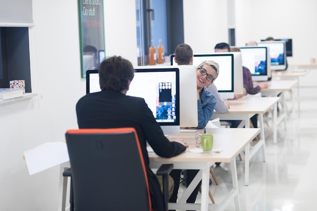 negocio de inicio, mujer que trabaja en una computadora de escritorio en una oficina creativa y moderna que se relaja y se divierte