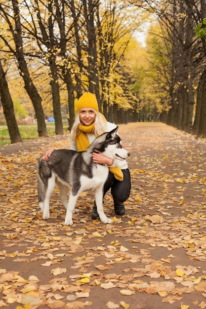 Nette Frau und Hund im Herbstpark