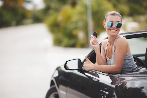 nette junge frau im cabrioletauto