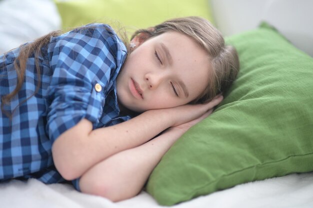 Nettes kleines Mädchen, das zu Hause im Bett schläft