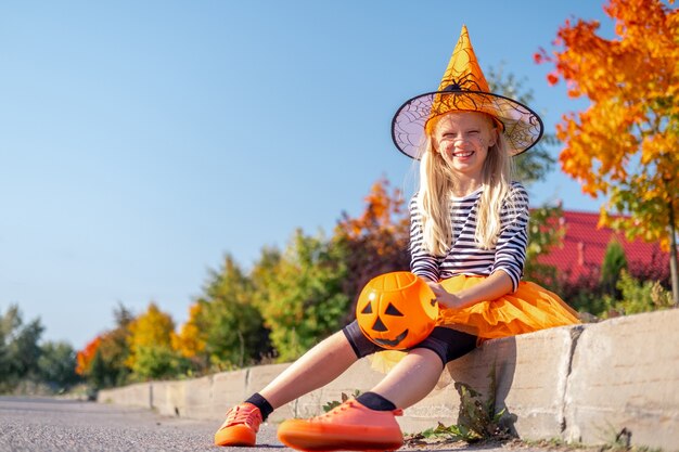 Nettes kleines Mädchen in einem Hexen-Halloween-Kostüm